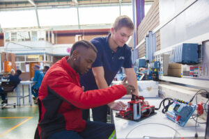 student and mentor working on something electrical