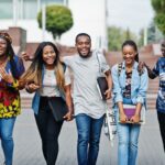 group-five-african-college-students-spending-time-together-campus-university-yard-black-afro-friends-studying-education-theme