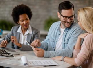 happy-man-talking-his-wife-while-using-touchpad-meeting-with-real-estate-agent-office
