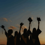 A group of graduates with their caps raised