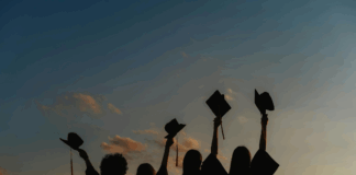 A group of graduates with their caps raised