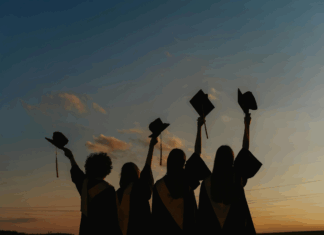A group of graduates with their caps raised