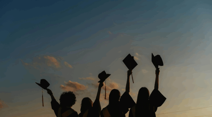 A group of graduates with their caps raised