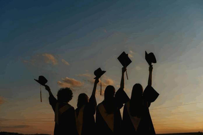 A group of graduates with their caps raised
