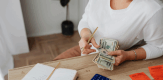 Photo by Photo By: Kaboompics.com: https://www.pexels.com/photo/woman-counting-money-at-the-desk-5900185/