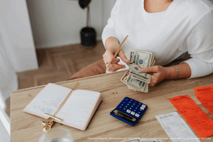 Photo by Photo By: Kaboompics.com: https://www.pexels.com/photo/woman-counting-money-at-the-desk-5900185/